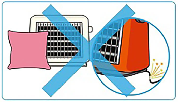 クッションがそばに置かれたストーブと、コードが切れているストーブの上に大きなバツマークが書かれたイラスト